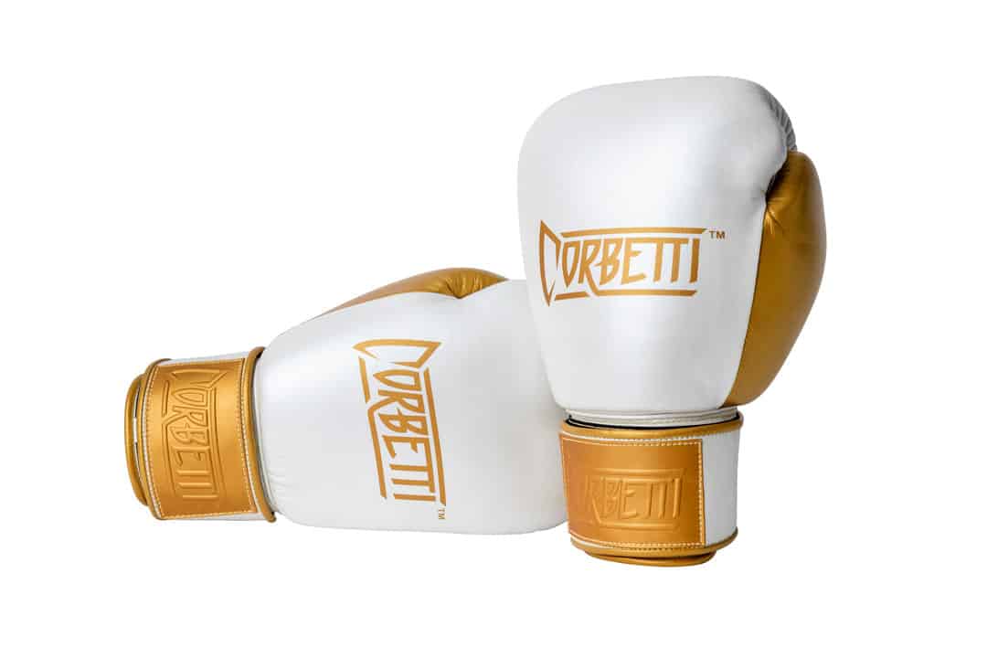 Corbetti CTG-005 Pearl White - Gold, Muay Thai Gloves right one laying down on its side fist side forward and left standing up showcasing the brand logos