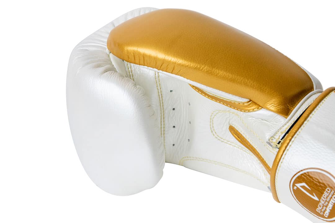 Corbetti CTG-005 Pearl White - Gold, Muay Thai right glove laying on its side thumb side up showcasing metallic gold thumb and palm detail