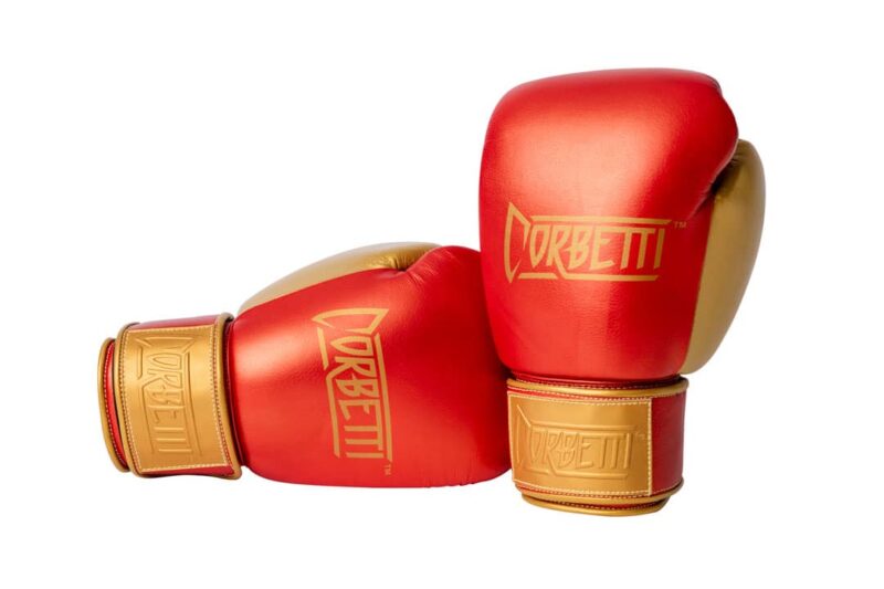 Corbetti CTG-002 Copper-Gold Muay Thai Gloves right one standing up and left one laying on its side both fist side forward highlighting the brand logos