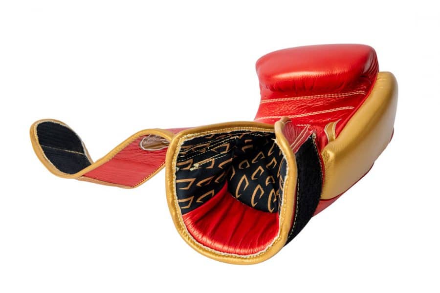Corbetti CTG-002 Copper-Gold Muay Thai Glove left hand laying fist side down displaying the inner printed fabric liner