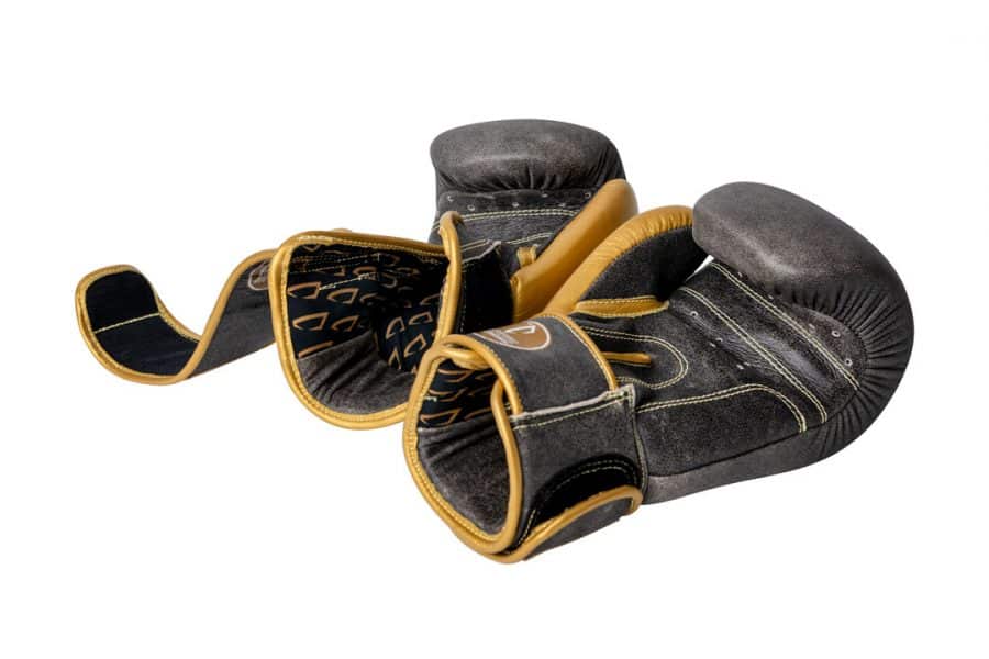 Corbetti CTG-006 Vintage-Gold Muay Thai Glove's left and right laying side by side on their backs giving a sneak peak at the inside leather and printed fabric liner