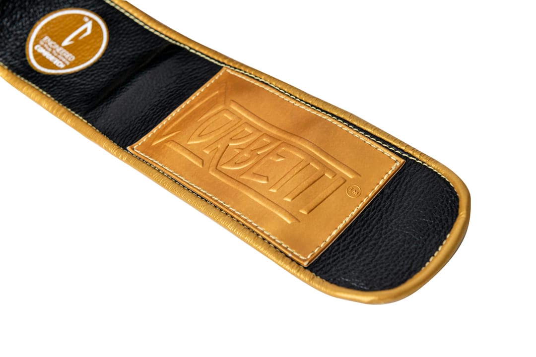 Corbetti CTG-001 Black-Gold Muay Thai Glove wrist label showcasing the gold rubber label with kevlar thread stitching
