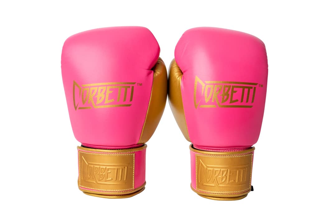Corbetti CTG-004 Pink-Gold Muay Thai Gloves both standing up fist side up showcasing the wrist labels and brand logos