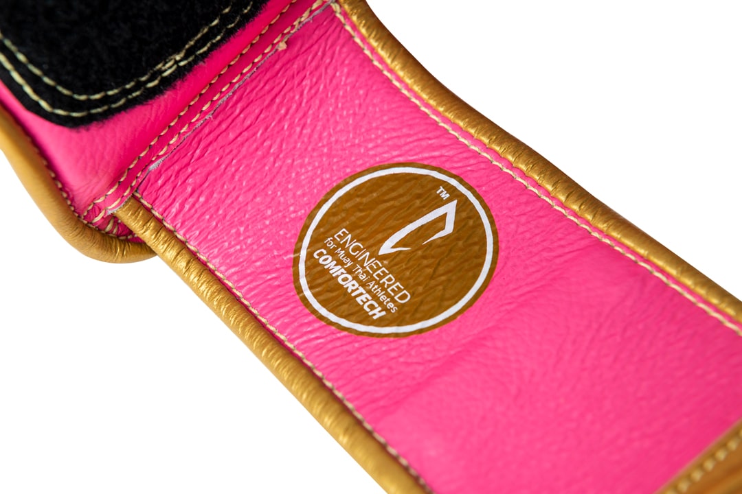 Corbetti CTG-004 Pink-Gold Muay Thai Glove's wrist strap showcasing the comfortech technology label