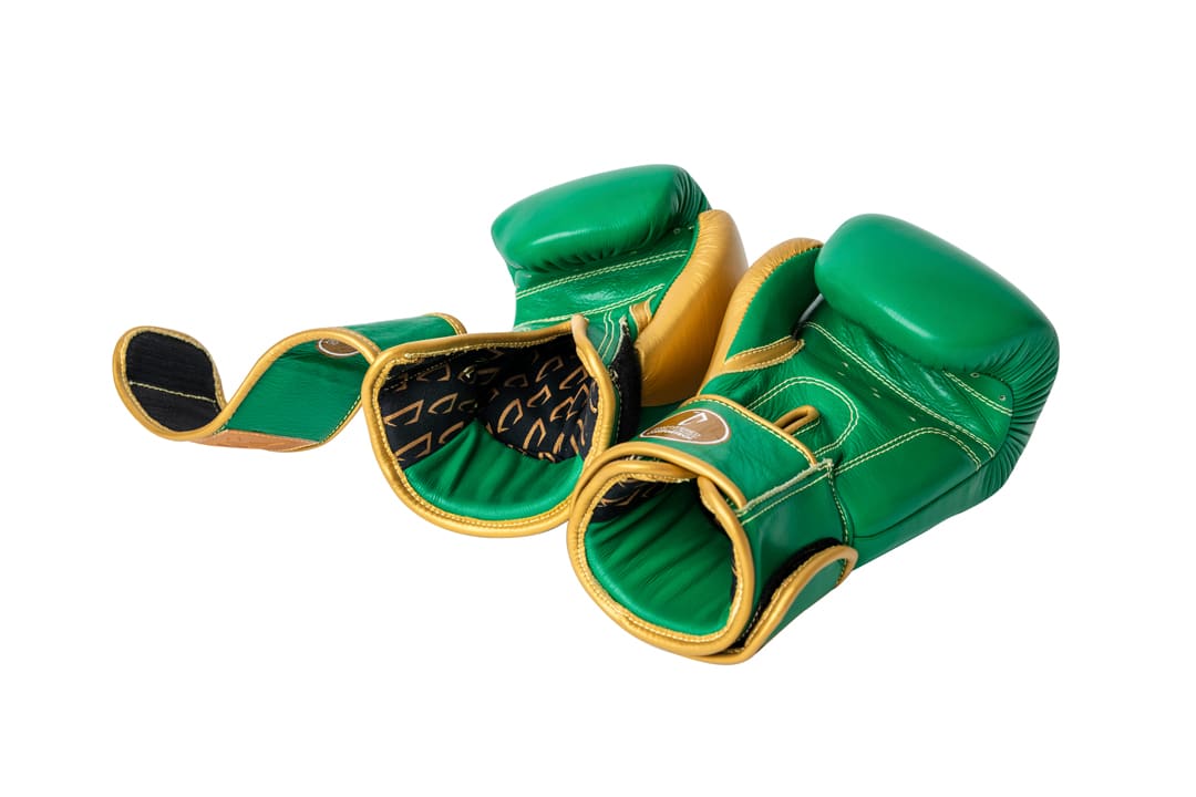 Corbetti CTG-003 Green-Gold Muay Thai Gloves both laying down on the fist side giving a sneak peak to the inside of the gloves