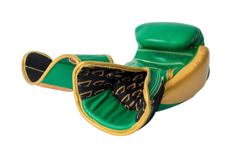 Corbetti CTG-003 Green-Gold Muay Thai Glove right hand laying on the fist side and showing the inside fabric liner