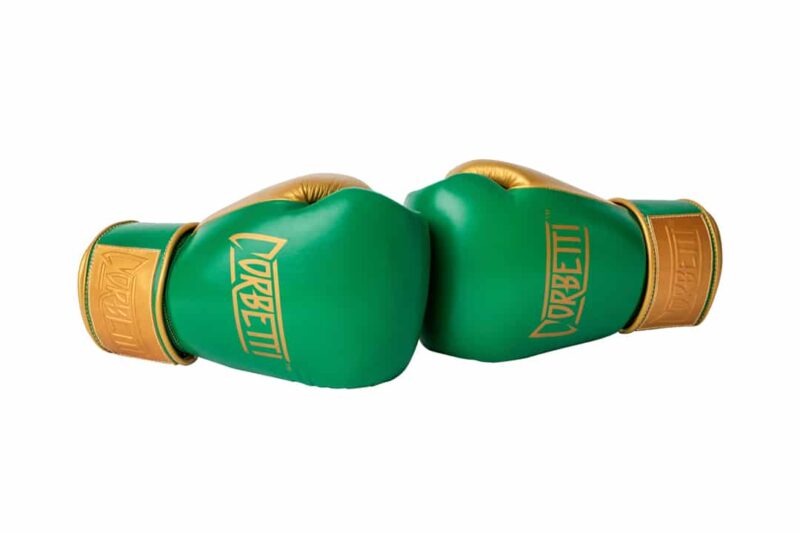 Corbetti CTG-003 Green-Gold Muay Thai Gloves both laying down on their sides touching knuckles fist side forward showcasing the brand's logos